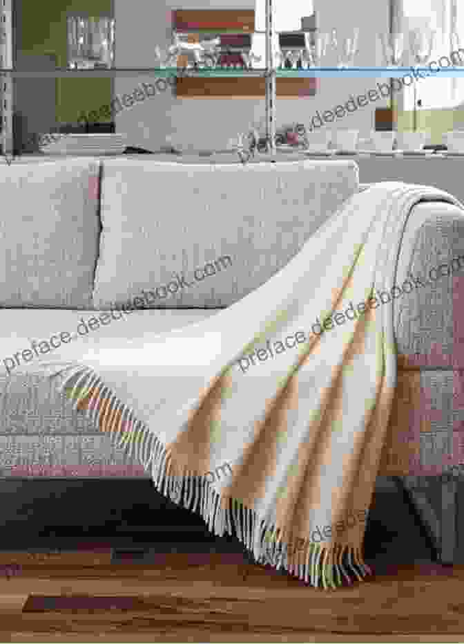 A Soft And Inviting Knitted Throw Draped Over A Couch, Exuding Warmth And Comfort. The Intricate Patterns Add A Touch Of Sophistication To Any Living Space. Filet Afghans: 8 Lovely Throws To Make While Learning To Use A Chart